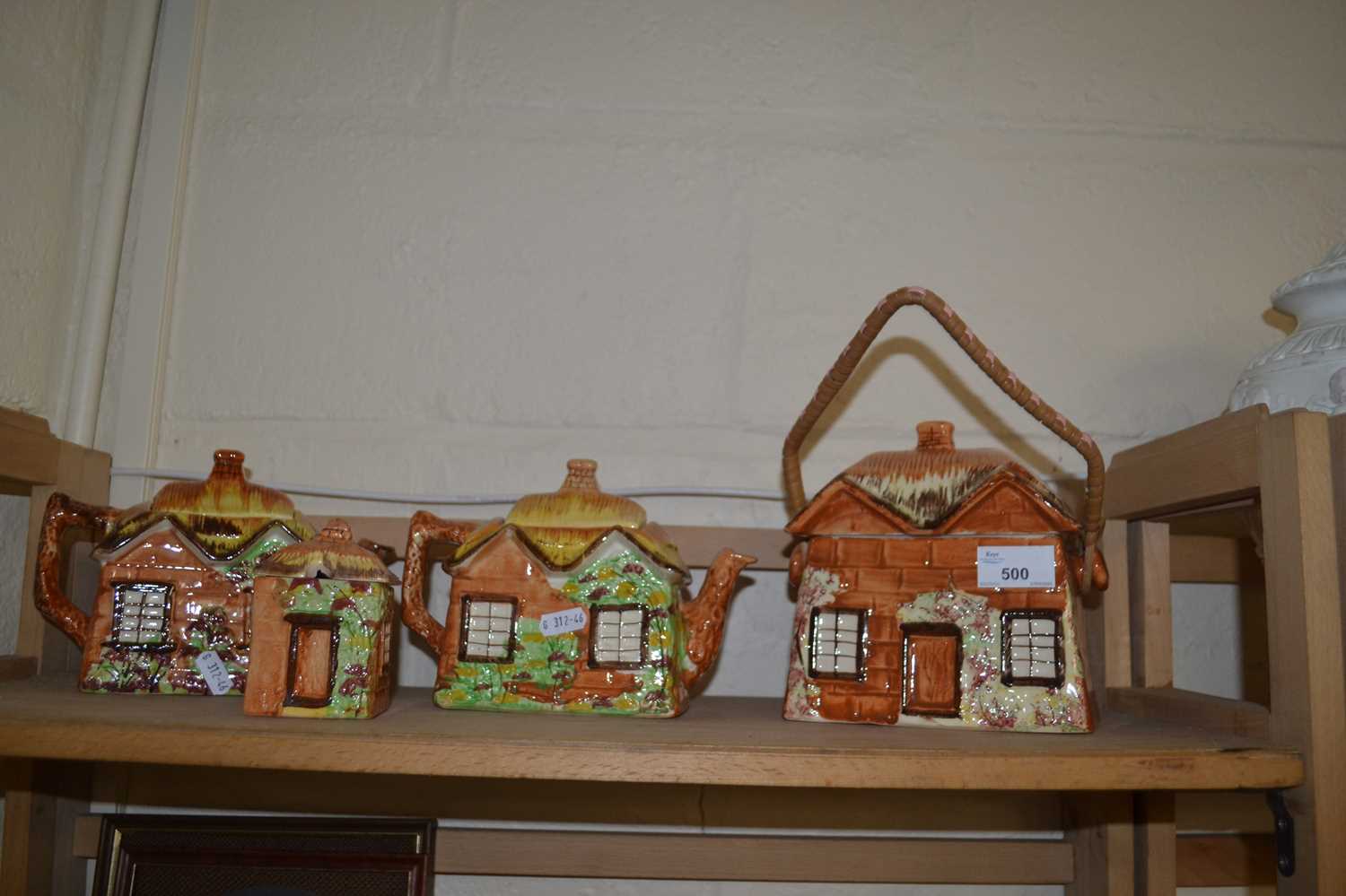 Two cottage ware teapots, biscuit barrel and a sugar bowl