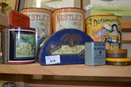 Two Nestle milk tins and other packaging and tins