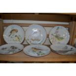 Seven hand painted plates by June Wendon of birds