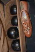 Cased set of four garden bowls and shoes
