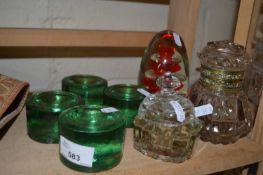 Four green glass paperweights together with another paperweight and an ink bottle and others