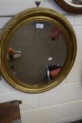 Oval bevelled wall mirror in gilt finish frame