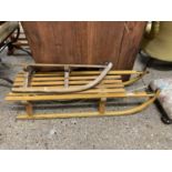 Wood sledge marked Davos plus one other smaller (2)