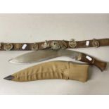 Mixed Lot: A leather belt mounted with various military cap badges together with a Kukri type knife