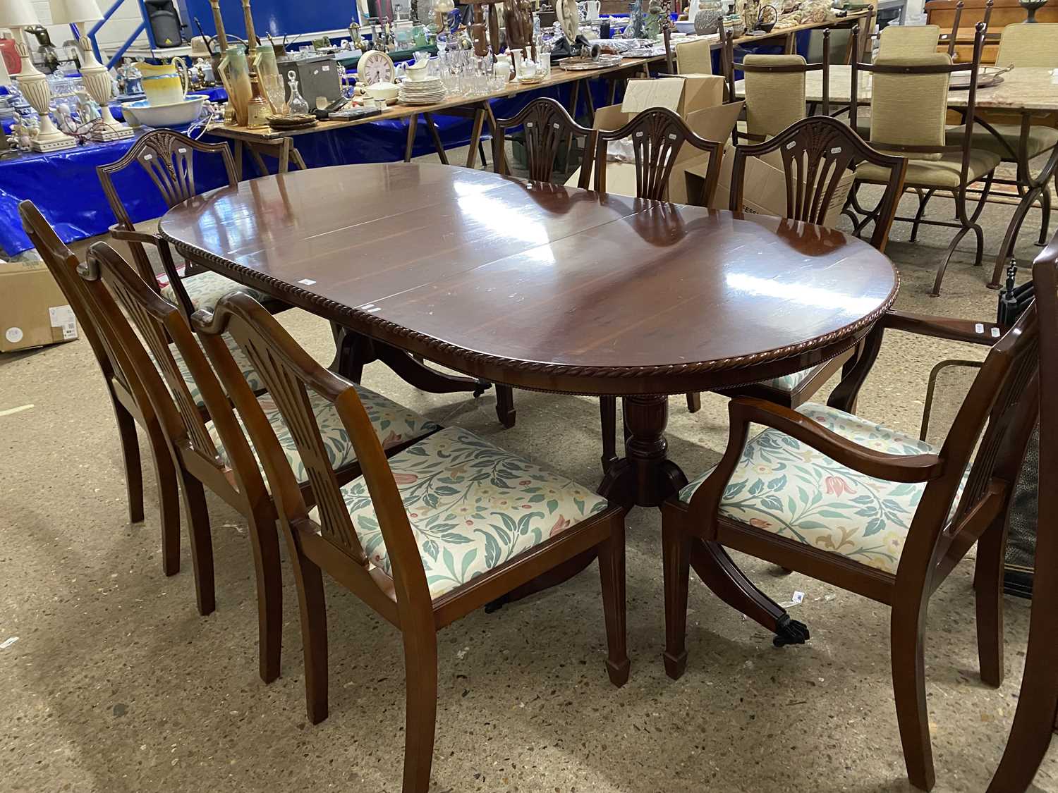 Modern yew wood veneered extending dining table and eight accompanying chairs