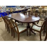 Modern yew wood veneered extending dining table and eight accompanying chairs