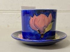 Small Moorcroft magnolia pattern oval formed vase and a similar pin tray (2)