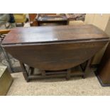 18th Century oval oak drop leaf dining table on turned legs