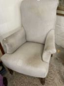 Grey upholstered armchair on turned legs