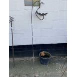 An iron and copper garden feature or bird feeder with oak leaf decoration
