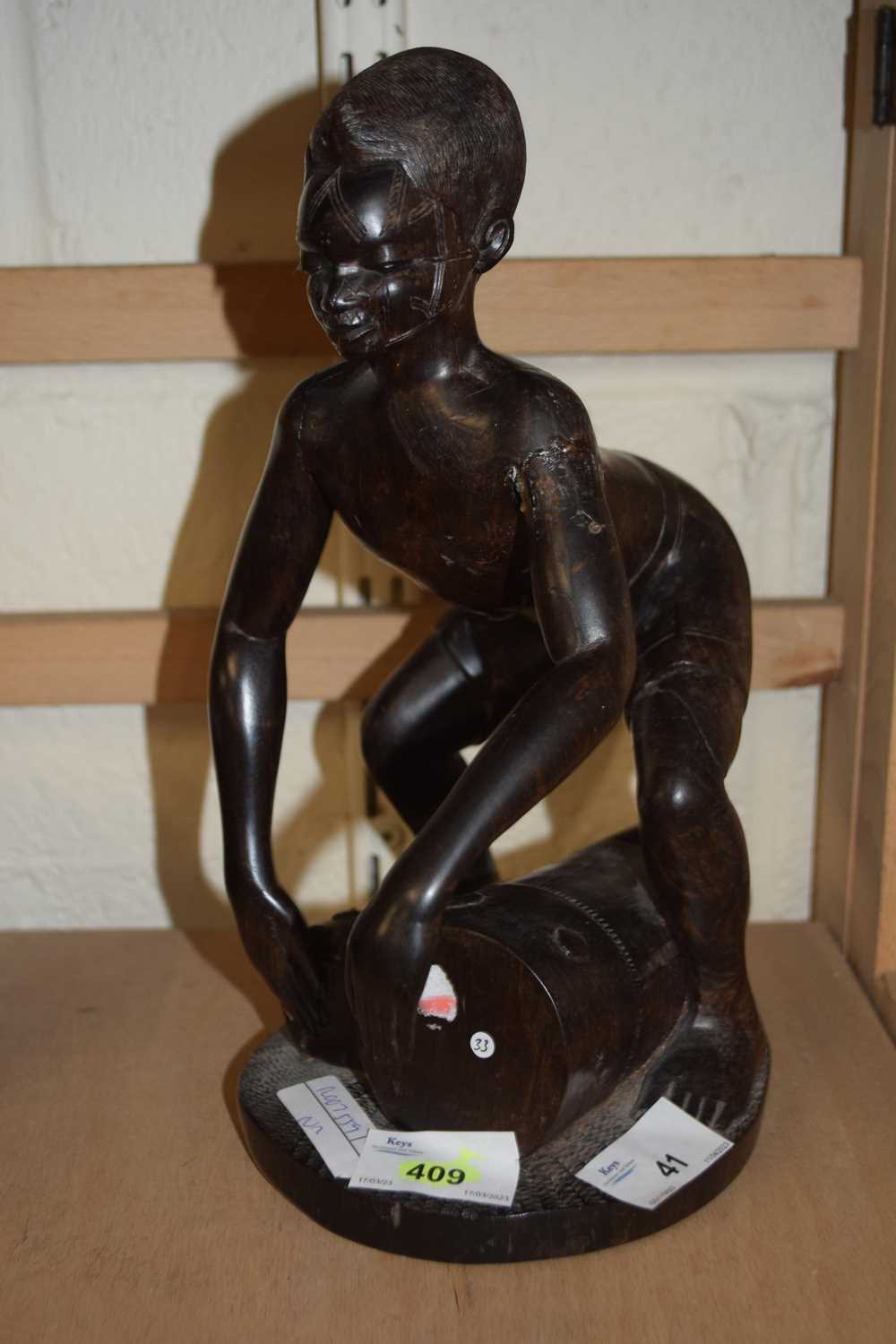 Carved African wooden figure of a drummer, 28cm high