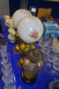 Two brass based oil lamps and one other (3)