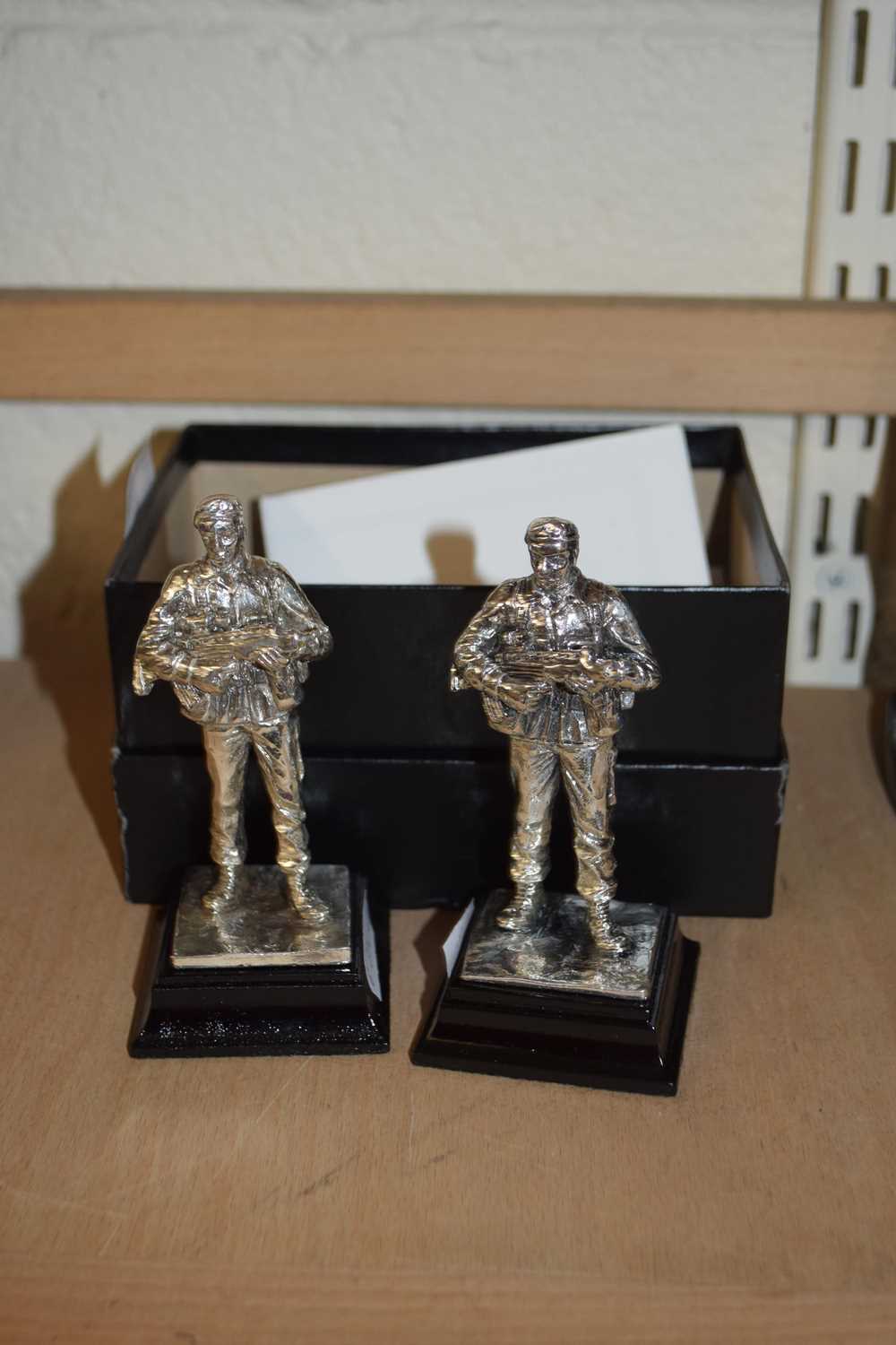 Two Royal Hampshire silver plated models of soldiers together with a further similar model owl