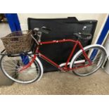 Vintage red painted bicycle with basket