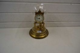 Brass anniversary clock with white dial with Arabic numerals set under a glass dome, 29cm high