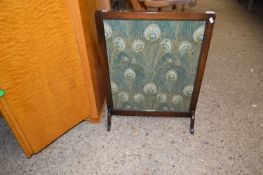 Fire screen decorated with peacock feather fabric
