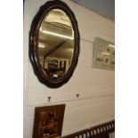 Early 20th Century oval bevelled wall mirror in a hardwood frame