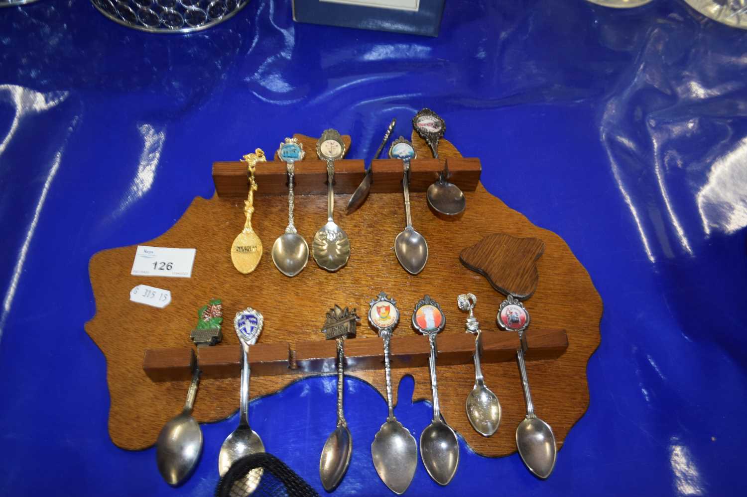 Australian wall display rack containing various crested spoons
