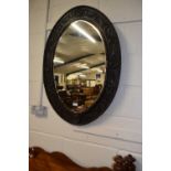 Late 19th Century wall mirror in oval carved frame, 92cm high