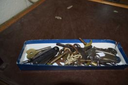 Box of various clock keys and pocket knives