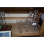 Two glass decanters and a set of six glasses engraved with animals