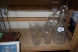 Two glass decanters and a set of six glasses engraved with animals