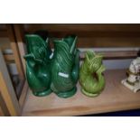 Two green glazed Dartmouth Pottery fish vases and another smaller