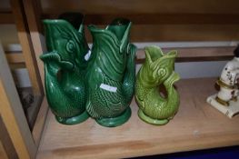 Two green glazed Dartmouth Pottery fish vases and another smaller