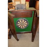 Winmau dart board set in a Chinese hardwood case with carved dragon detail, 81cm wide