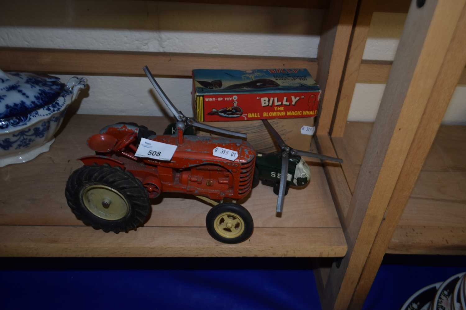 Model Massey Harris tractor together with a toy helicopter and Billy the Ball Blowing Magic Whale