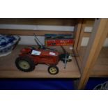 Model Massey Harris tractor together with a toy helicopter and Billy the Ball Blowing Magic Whale