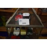 Small glass display cabinet containing various model cars