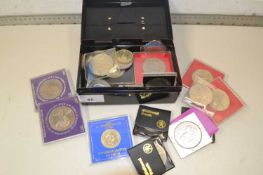 Small cash tin containing various commemorative British coinage