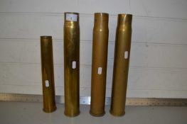 Group of four brass shell cases, largest 37cm high