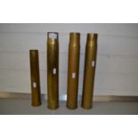 Group of four brass shell cases, largest 37cm high