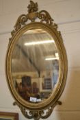 20th Century oval wall mirror in gilt effect frame