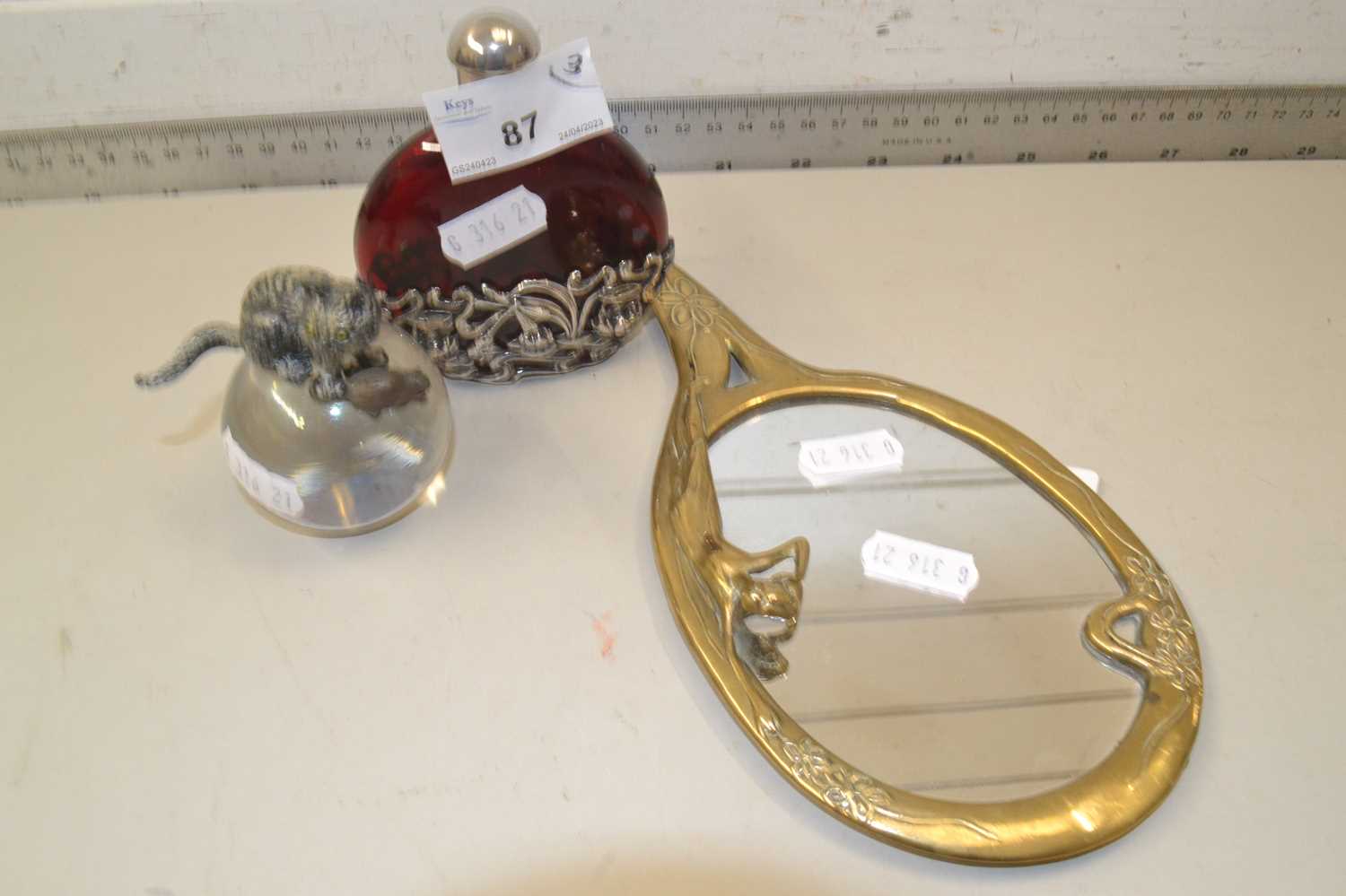 Mixed Lot: Ruby glass scent bottle with metal mounts, a brass framed Art Nouveau style hand mirror