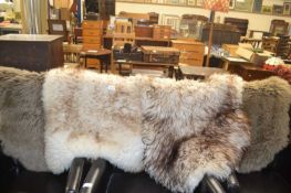 Four various small sheepskin rugs