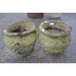 Pair of small concrete vase formed pots with geometric decoration, 27cm diametre