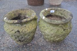 Pair of small concrete vase formed pots with geometric decoration, 27cm diametre