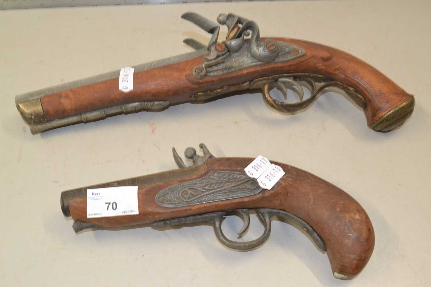 Two reproduction flint lock pistols