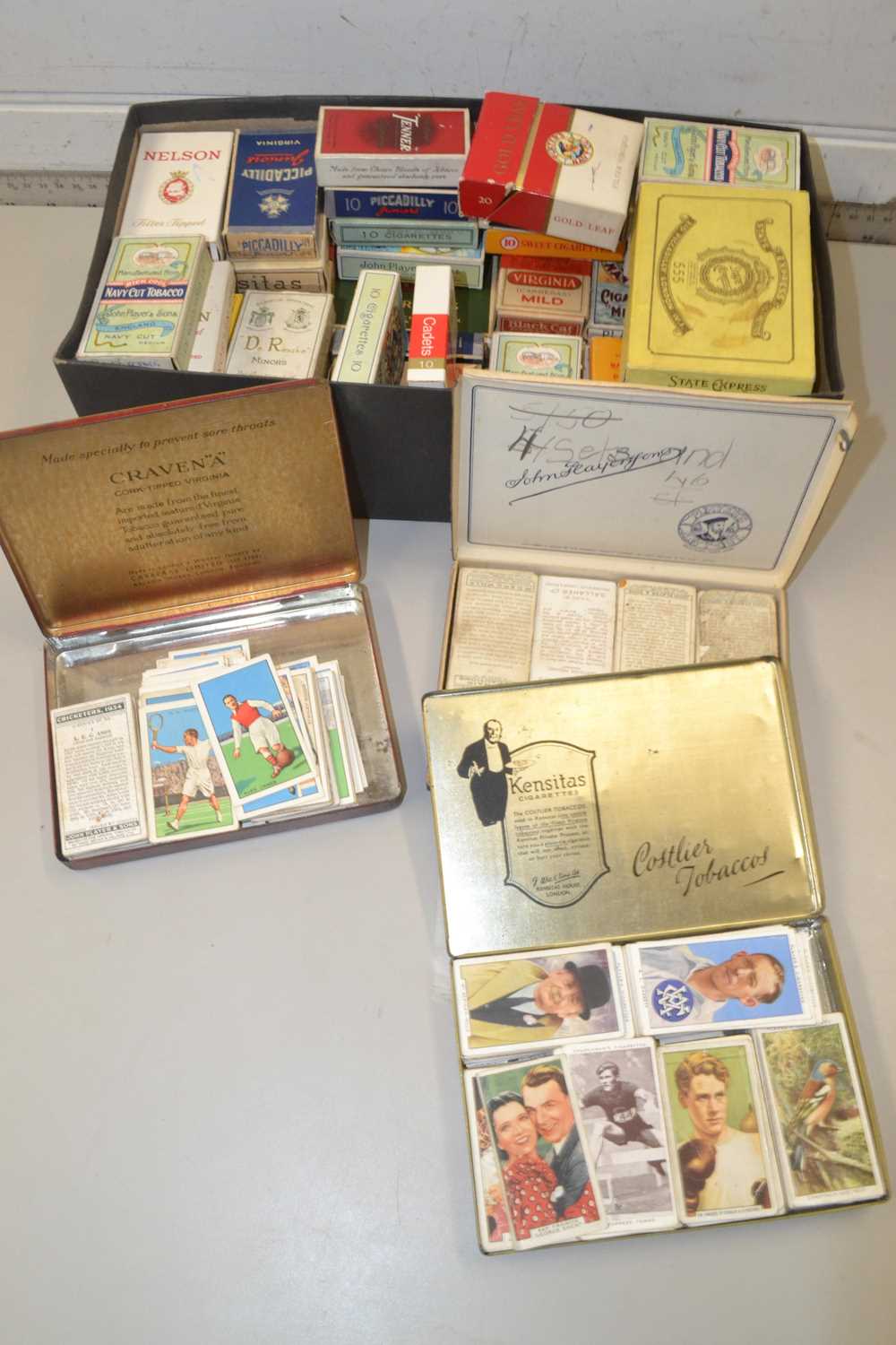 Shoe box of various boxes of cigarette cards