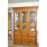 Modern lounge display cabinet with illuminated top section over a cupboard base