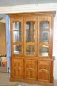 Modern lounge display cabinet with illuminated top section over a cupboard base