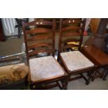 Four ladder back dining chairs