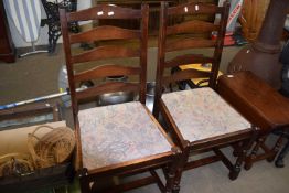 Four ladder back dining chairs