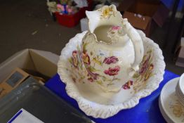 Wash bowl and jug decorated with flowers and gilt trim