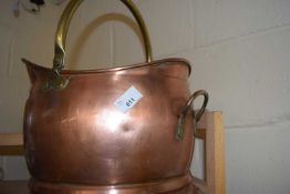 A copper and brass handled coal scuttle