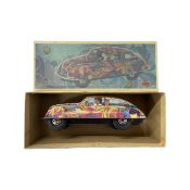 A boxed tin plate friction drive vehicle modelled as a psychedelic 60s car driven by Jimi Hendrix,