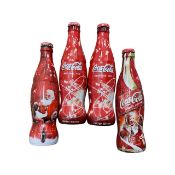 Four full 2002 Limited Edition Coca Cola Christmas bottles